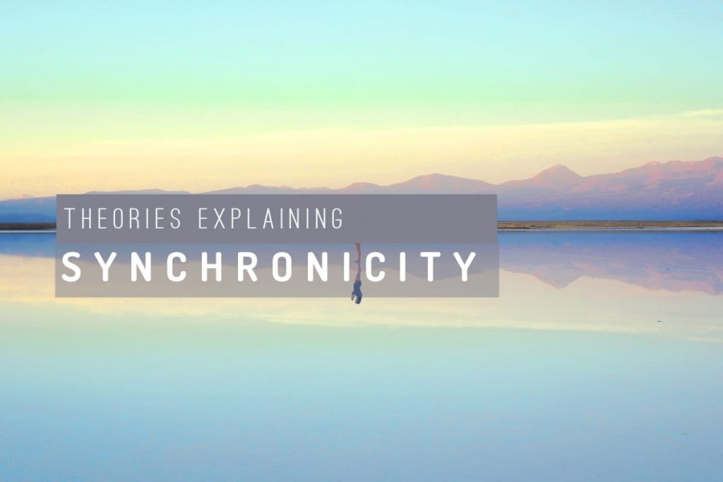 theories explaining synchronicity overlaid words over a lake with reflections of mountainous country