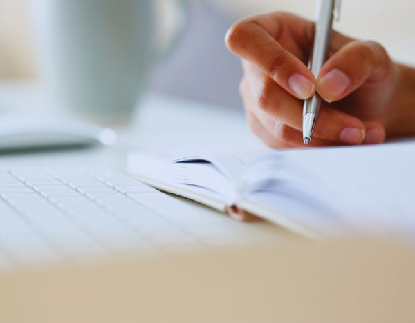 a person writing in a journal